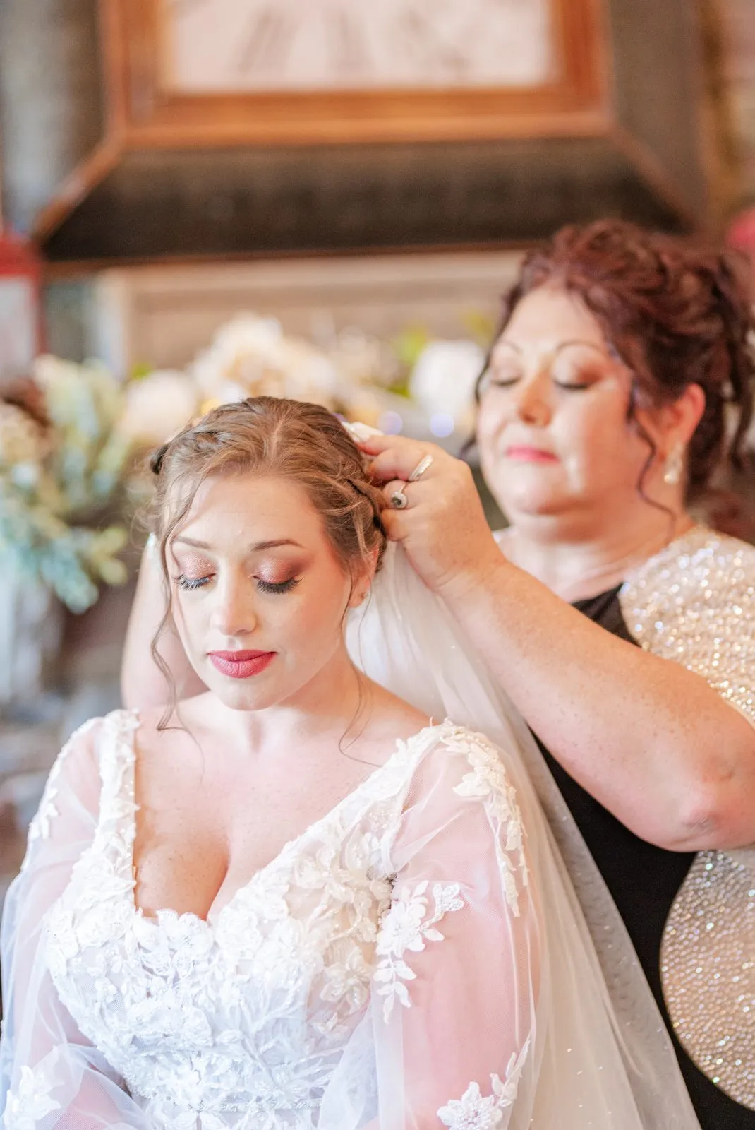 Bride getting ready as her veil is placed in the bridal suite at The Heritage Barn
